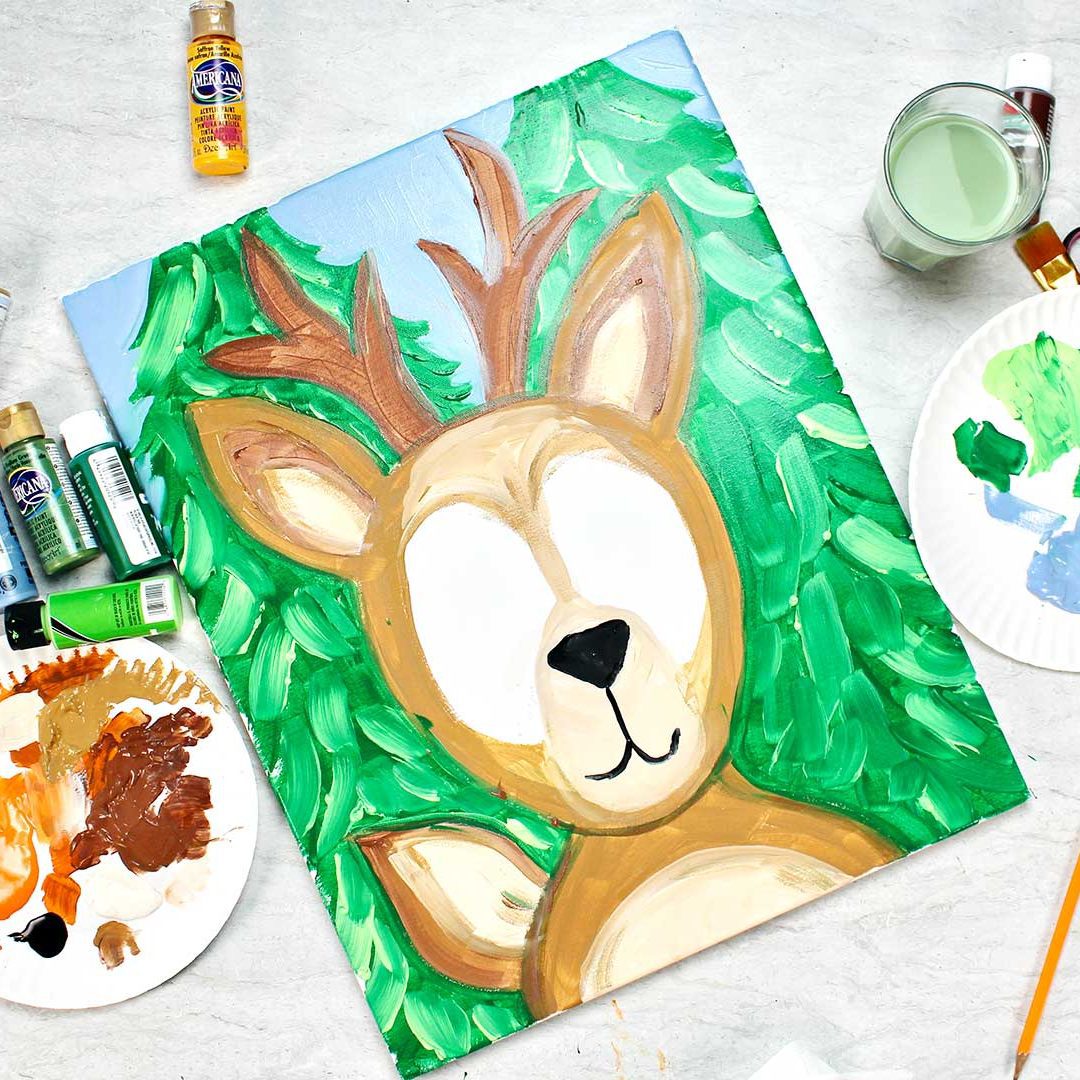 Almost completed deer photo frame prop with painting supplies near by.