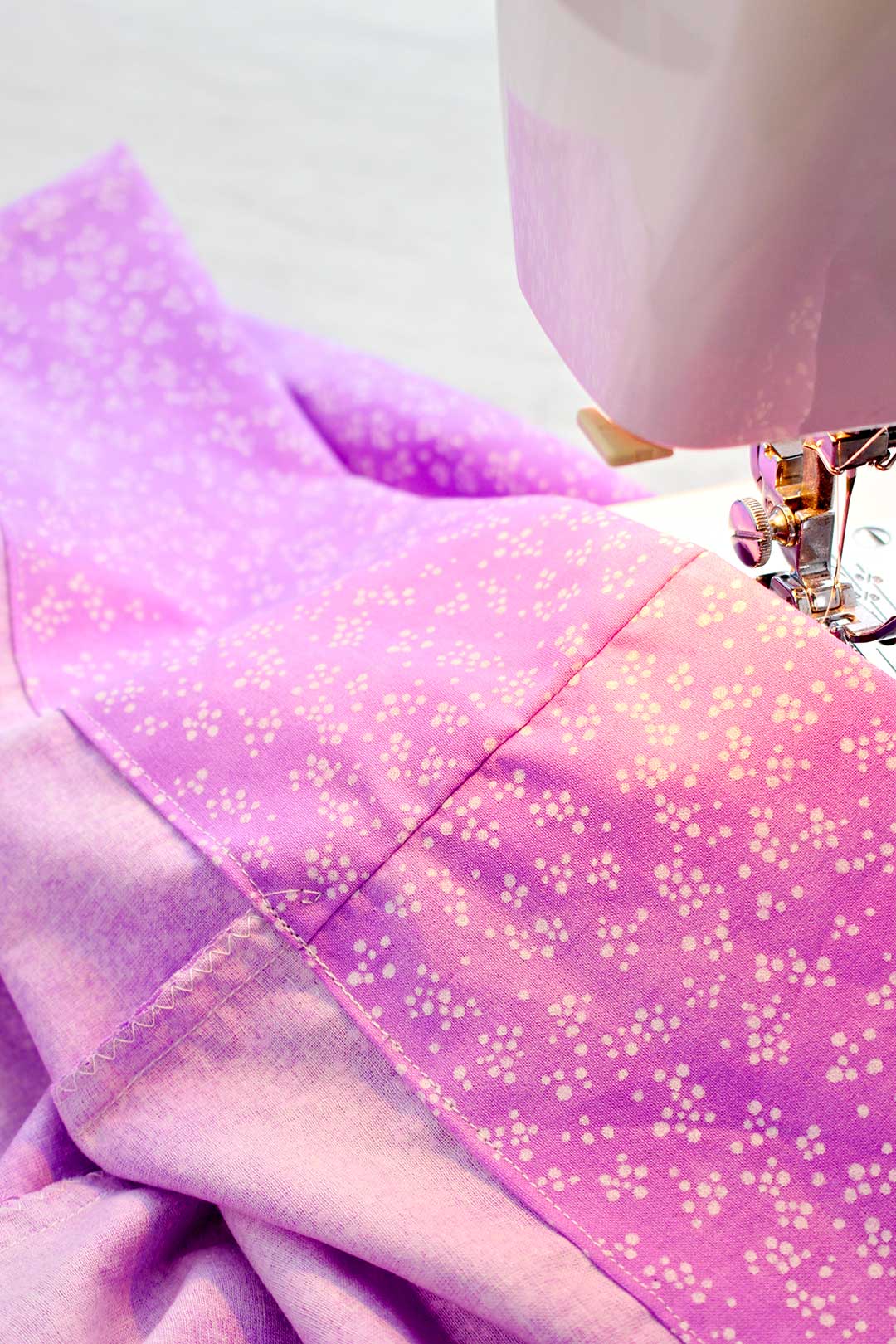 Close up image of the hemmed opening of the pillowcase near the sewing machine.