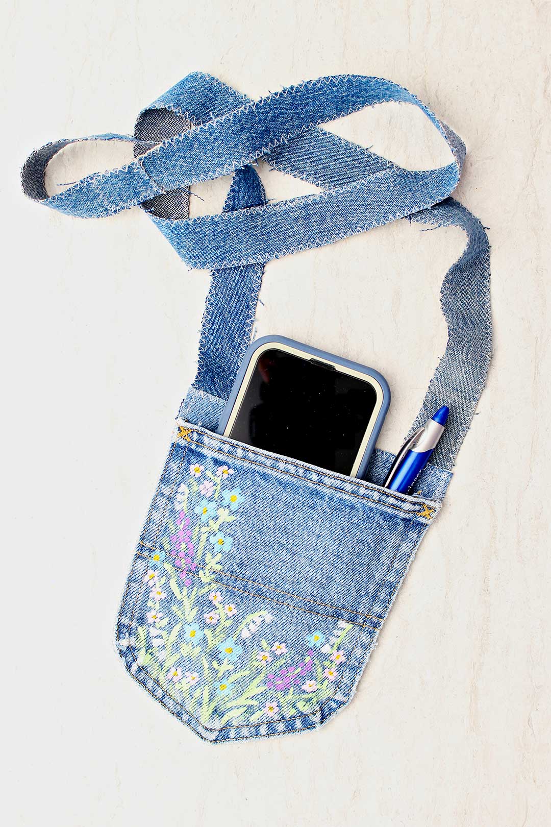 Completed jeans pocket purse with cell phone and pen inside.