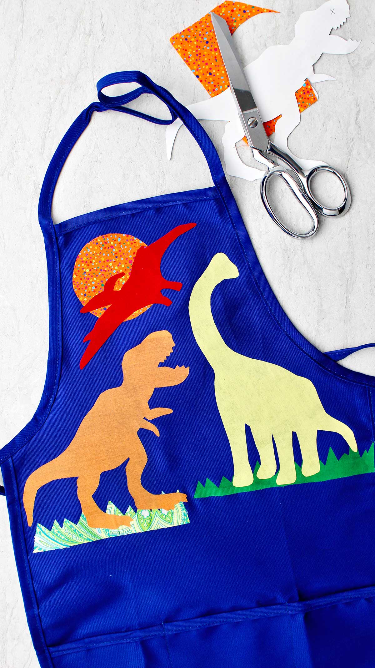 Completed dinosaur decorated apron using no sew appliqué technique.