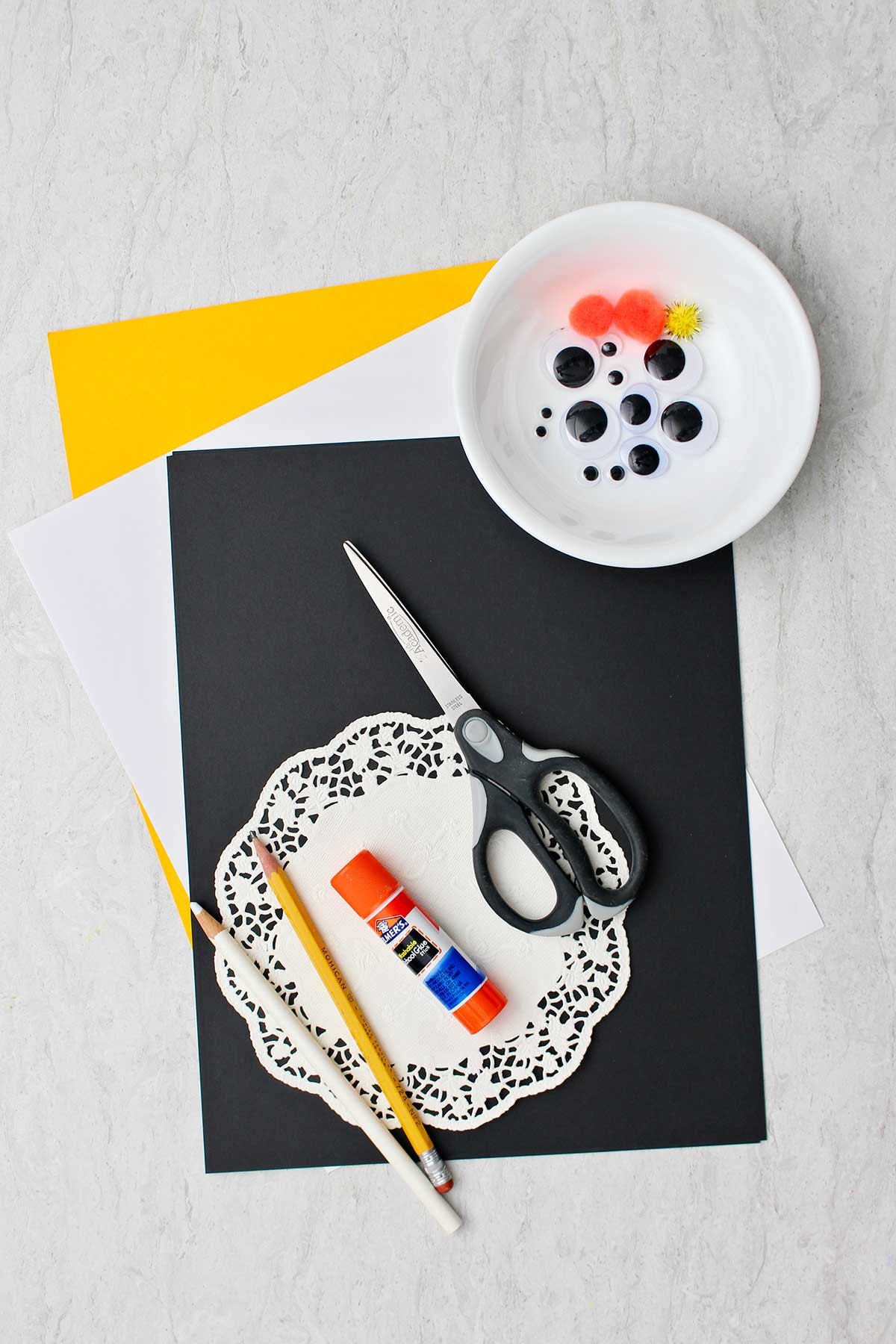 Supplies needed for Easy Paper Penguin Craft. Googly eyes, paper, doily. scissors, glue and pencils.