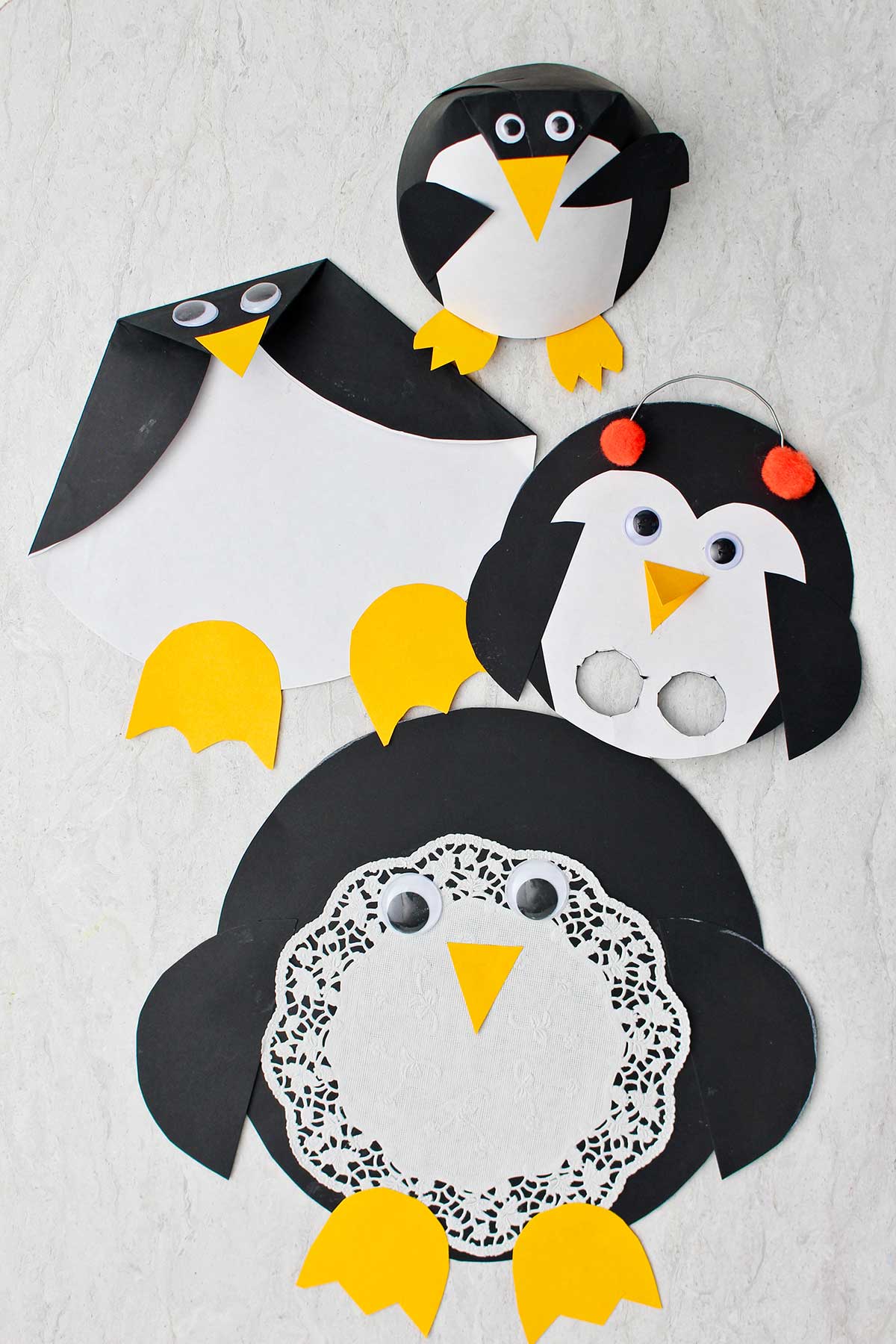 Four completed Paper Penguin Crafts.