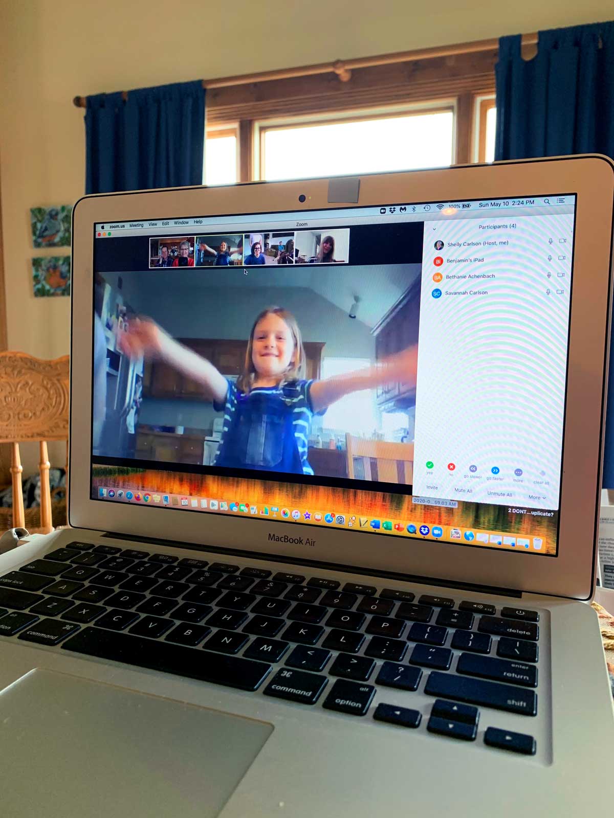 A computer with a video chat open, with a child sending a virtual hug