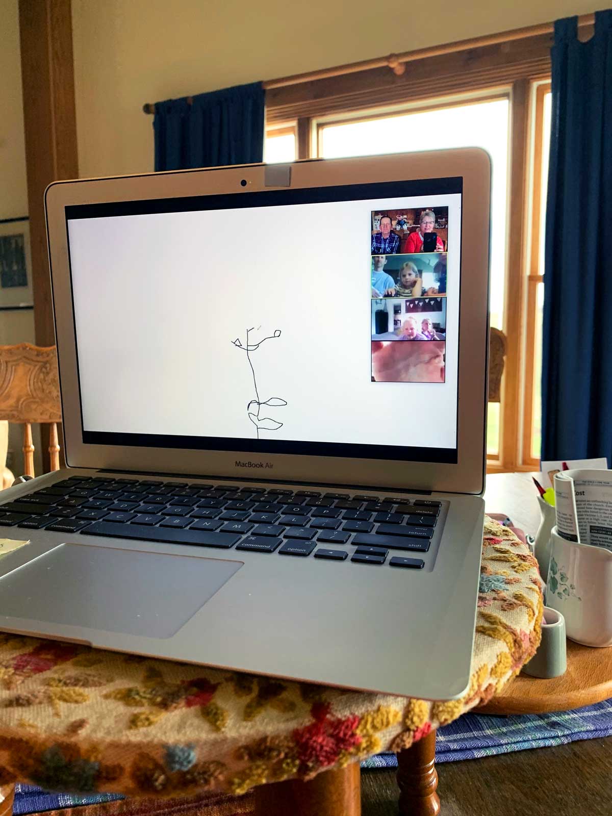 A computer with a video chat open, with pictionary being played virtually