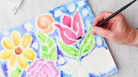 Hand painting details on red tulip in glue line painting.