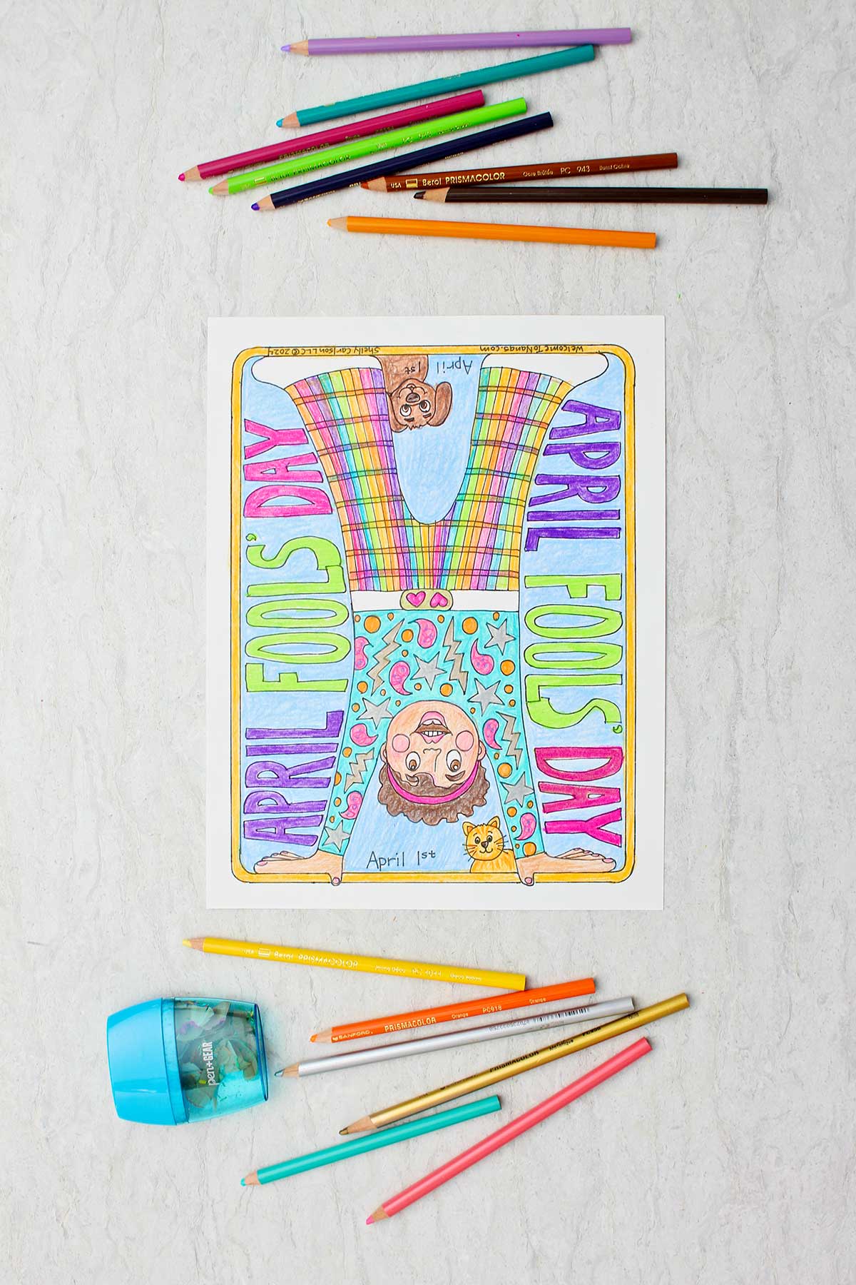 Fully colored April Fools Day Coloring Page of a person doing a handstand in a colorful outfit with colored pencils and a sharpener near by.