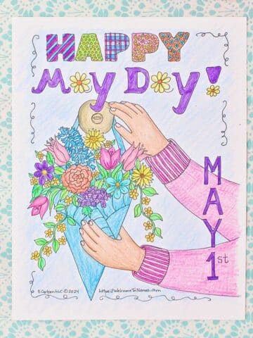 A May Day coloring page on a clip board being colored with coloring pencils