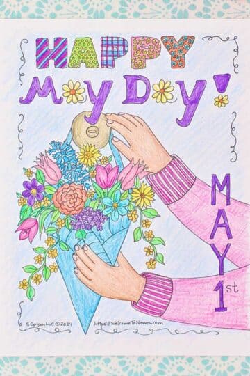 A May Day coloring page on a clip board being colored with coloring pencils