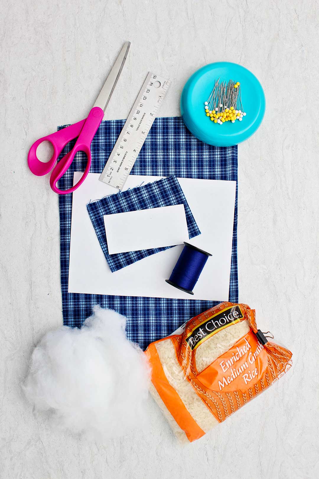 Supplies needed to make Cell Phone Holder Pillow. Scissors, ruler, straight pins, fabric, thread, dried rice and cotton.