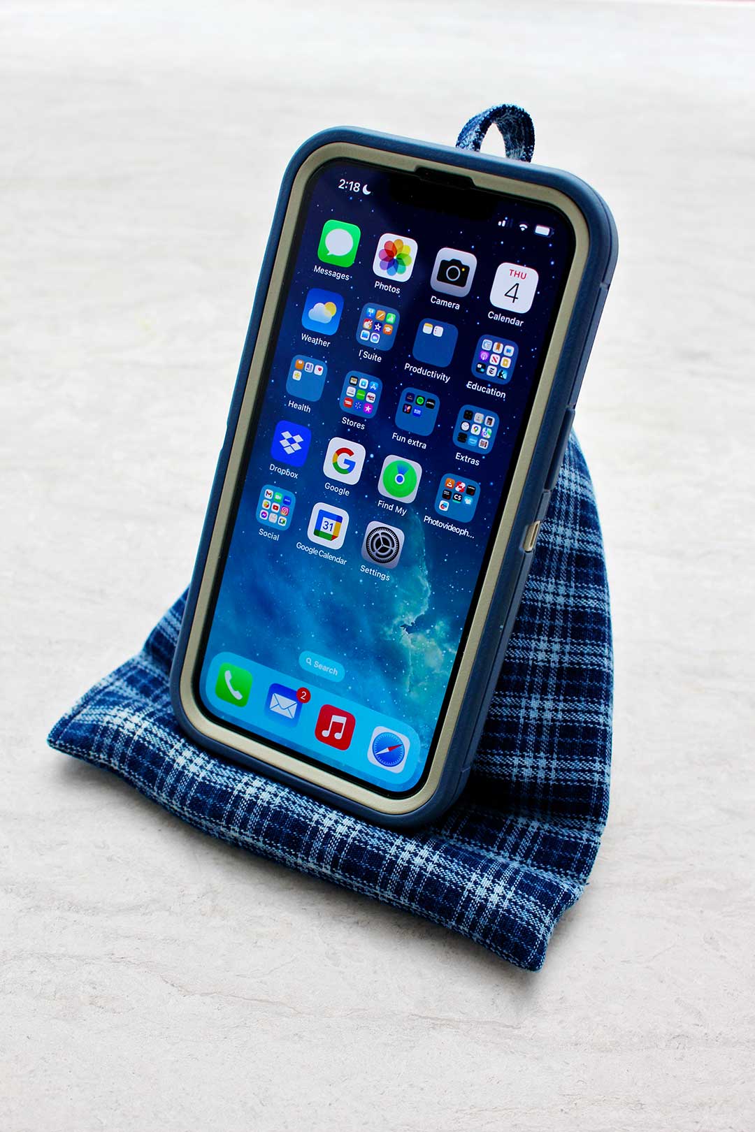 Completed Cell Phone Holder Pillow holding cell phone with blue case.