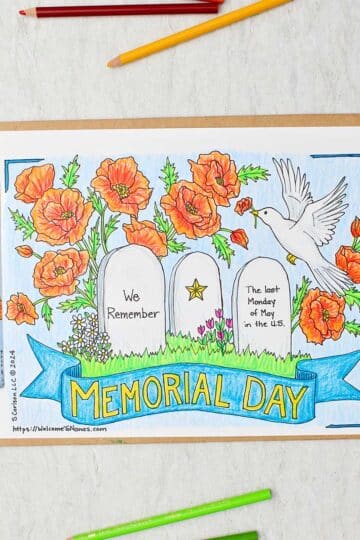 Completed Memorial Day Coloring Page on clip board. Coloring page has three headstones, flowers and bird and Memorial Day banner.