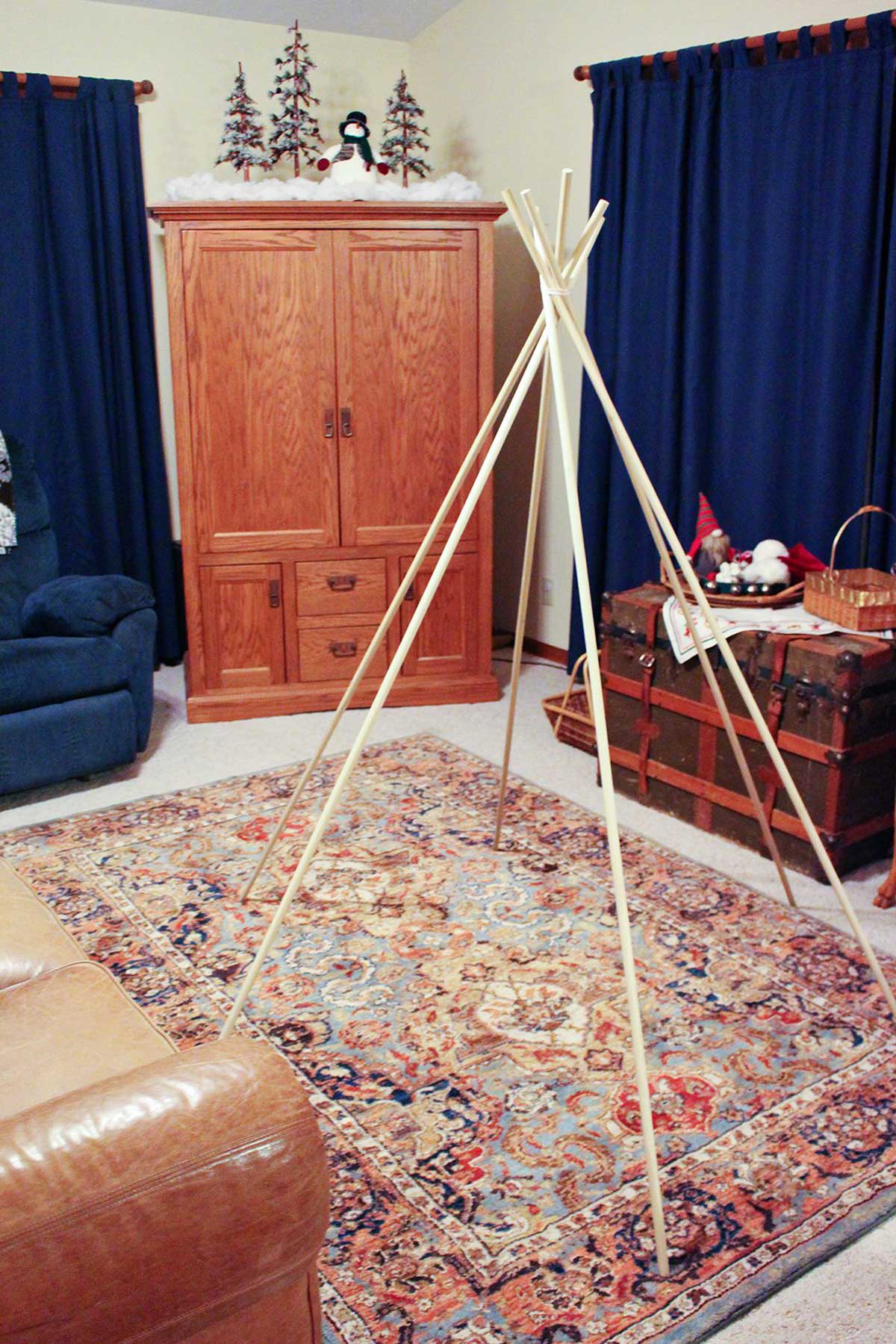 6 dowel rods tied together at the top to create a teepee-style tent frame.