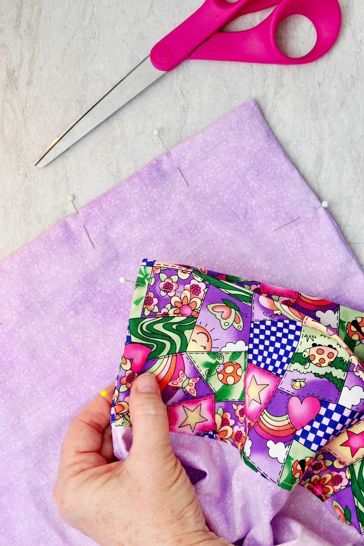 Person showing how to pin pillowcase before sewing.