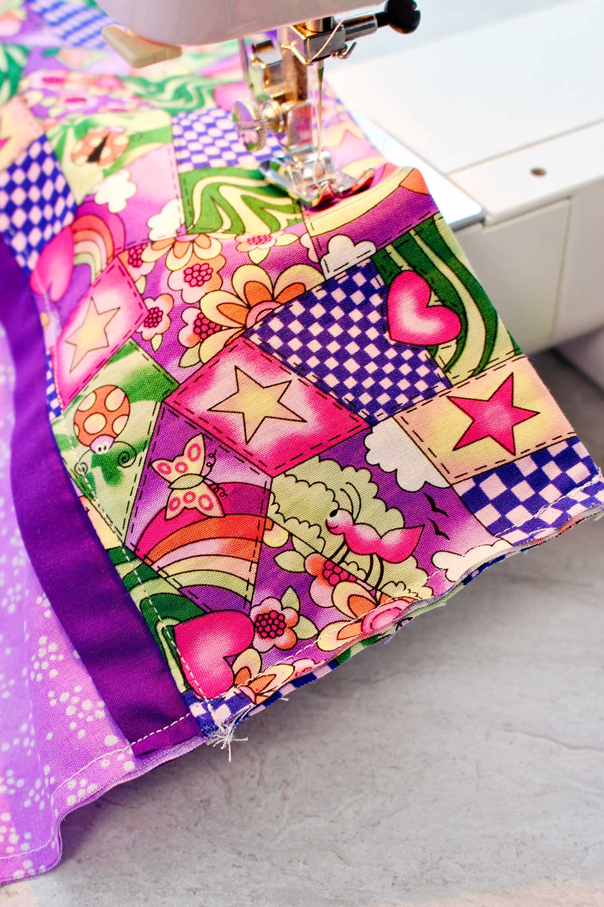 Close up view of pillowcase being sewn on a machine.