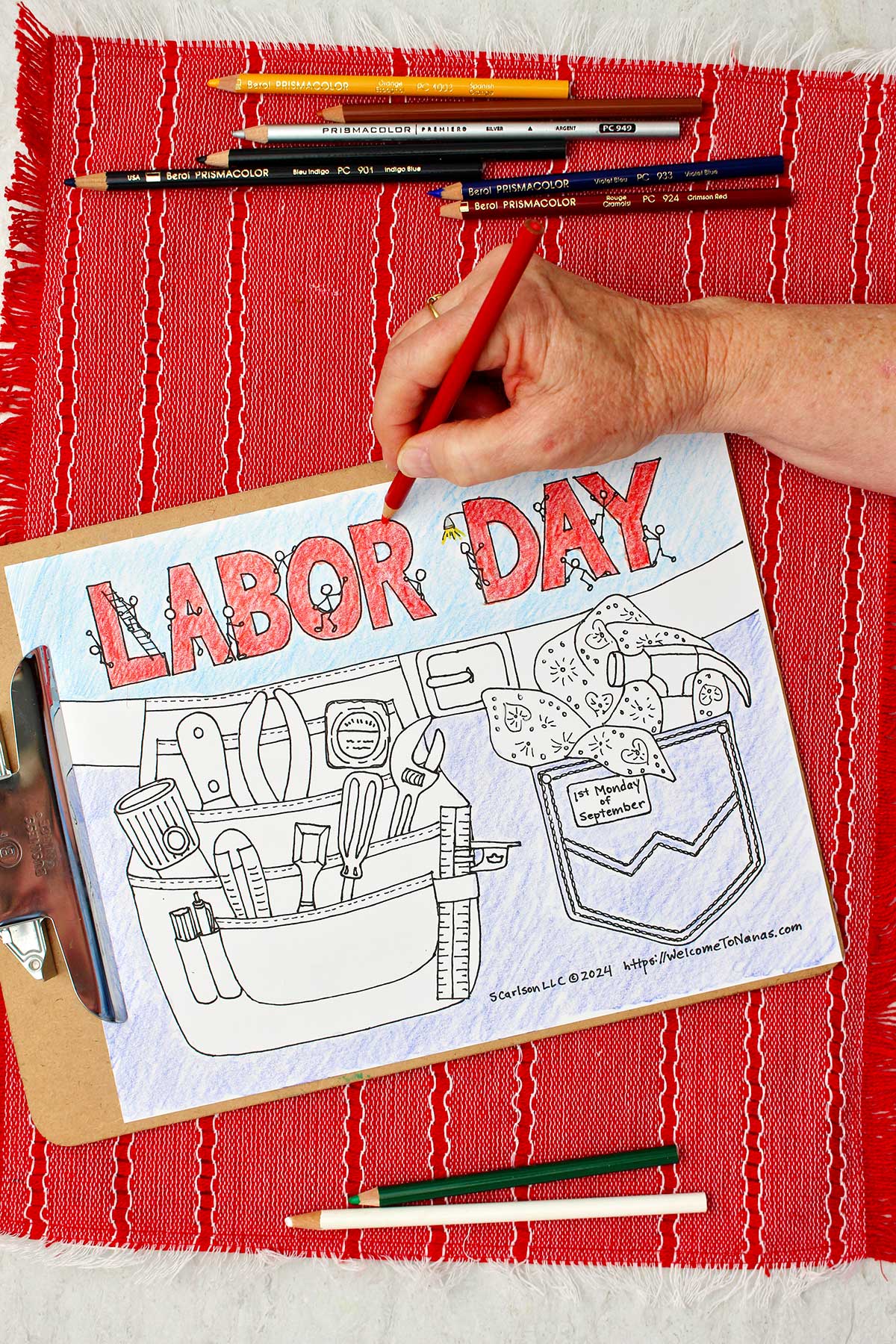 Person coloring "Labor Day" red on Labor Day coloring page.