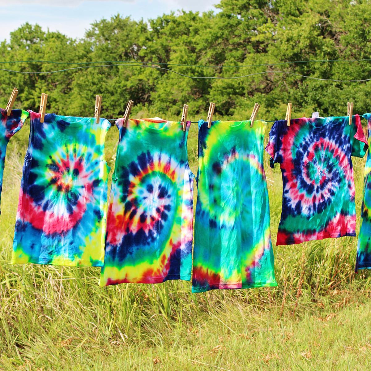 Tie-dye shirts hanging to dry on a clothesline