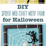 Spider decoration attached to a DIY spider web made from yarn and attached to a black photo frame in front of a yellow back drop and an image in front of an aqua back drop.