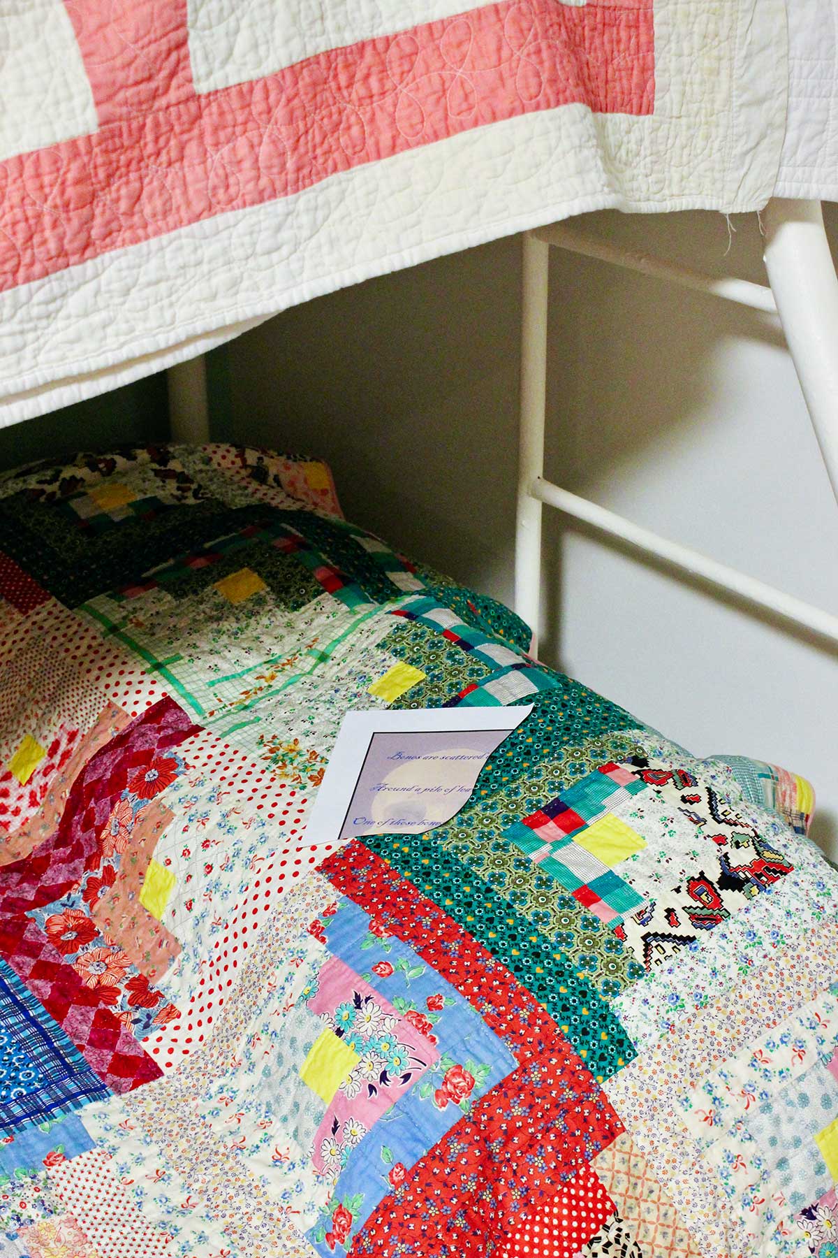 A scavenger hunt printable page on a quilted bottom bunk bed.