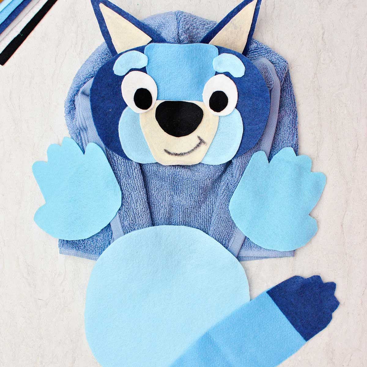 A blue healer Halloween costume made from felt and a blue terrycloth towel.