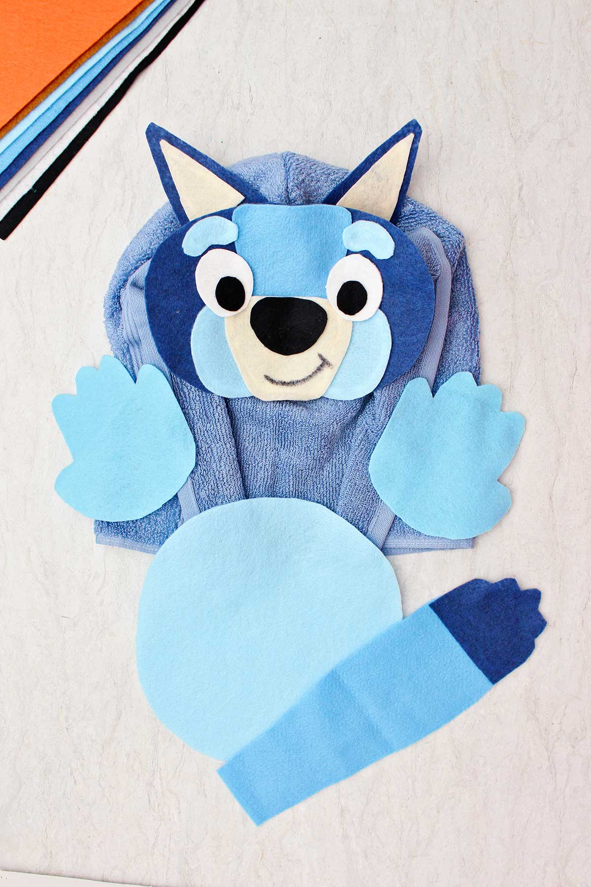 A blue healer Halloween costume made from felt and a blue terrycloth towel.