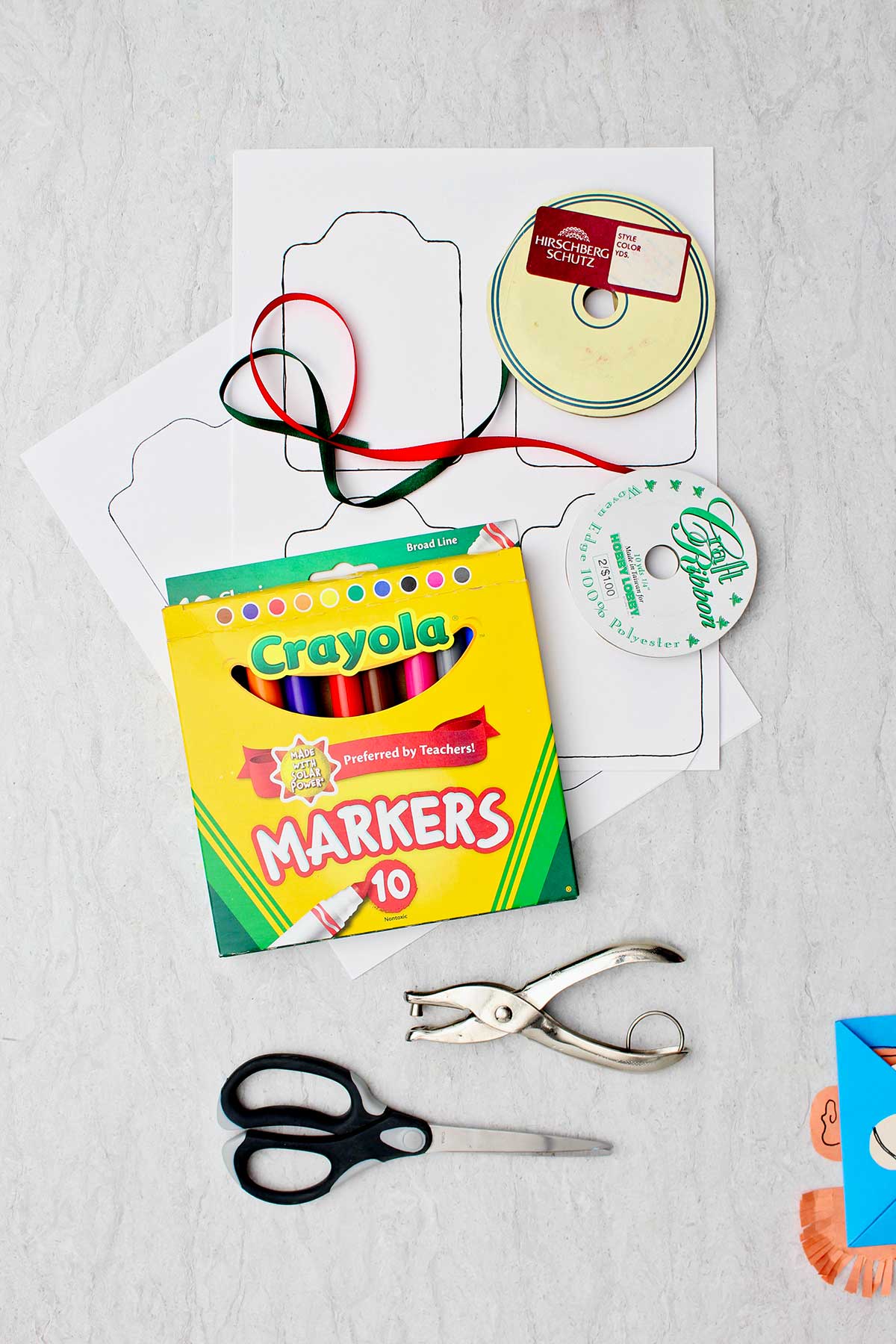 Markers, printable tags, ribbon, scissors and a hole punch.