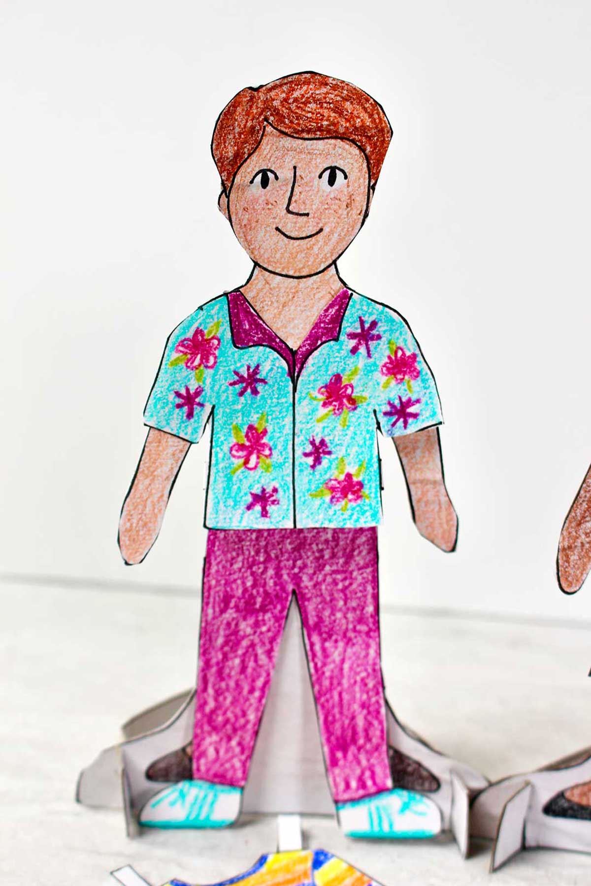 Paper Doll boy completed with red hair and colorful clothing.