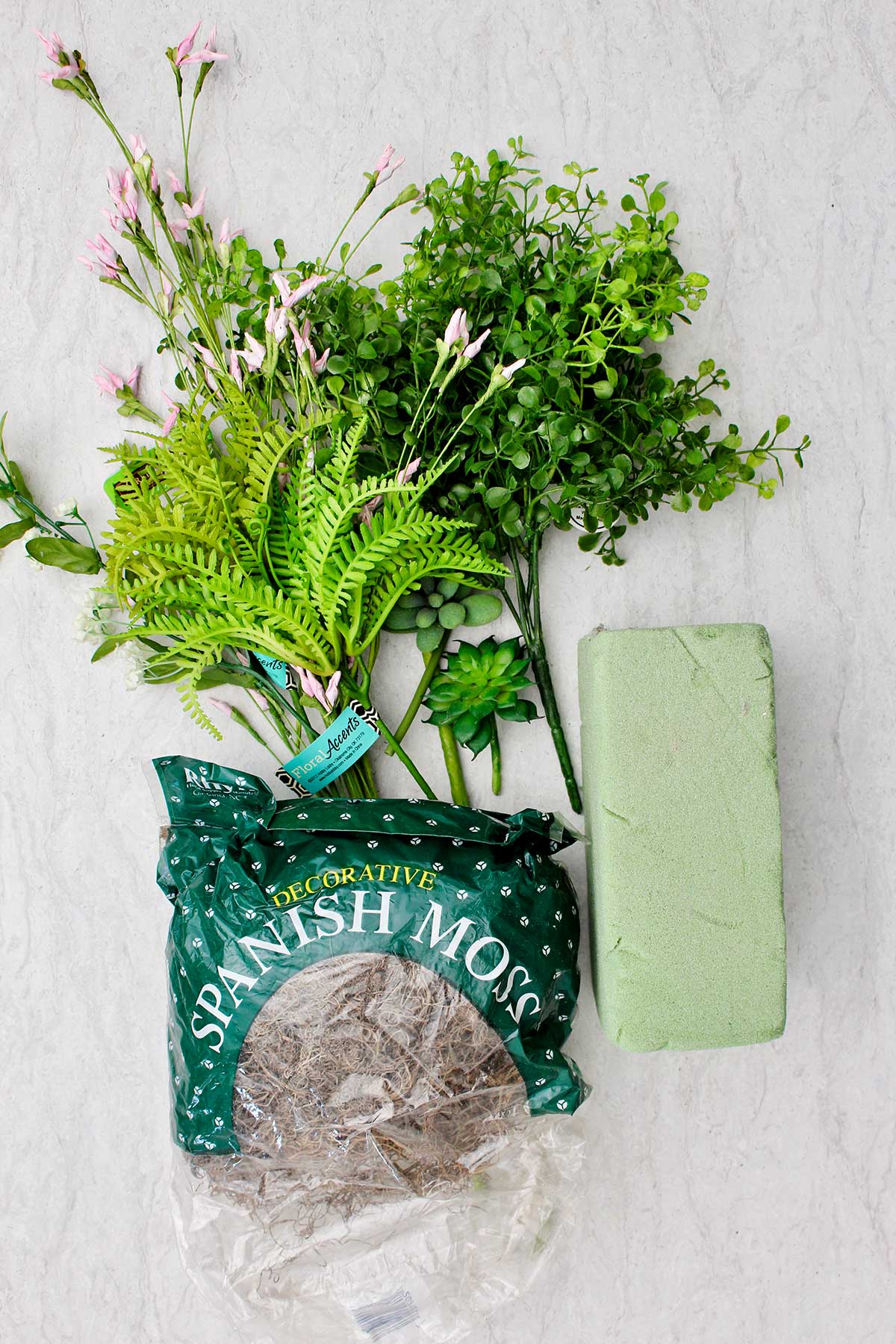 Spanish moss, a green foam block and fake foliage.