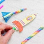 Three colorfully colored straw rockets.