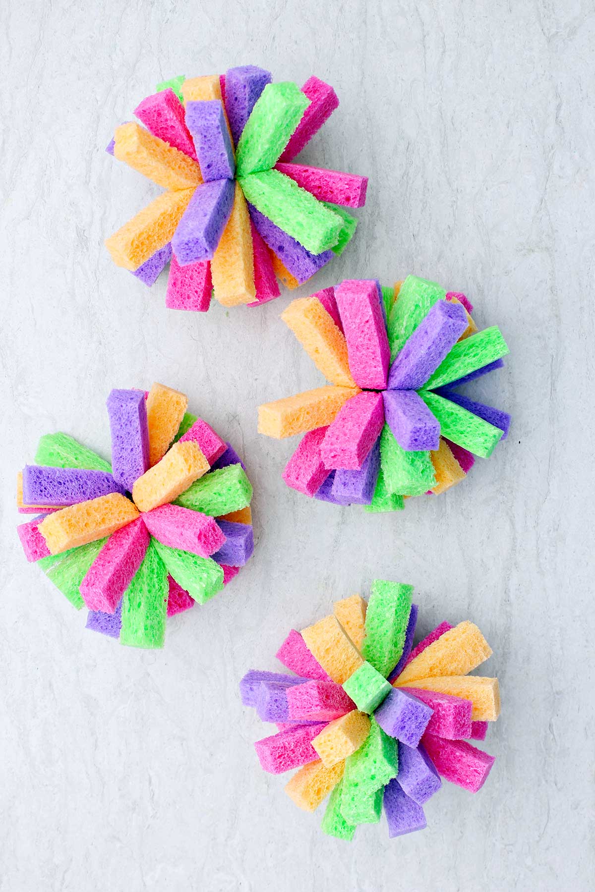 Four completed multi colored sponge bombs.