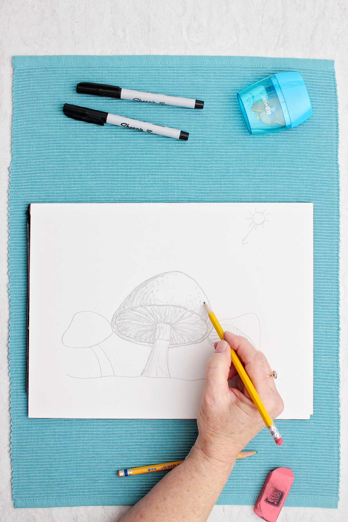 A pencil sketch of a mushroom, shading being added
