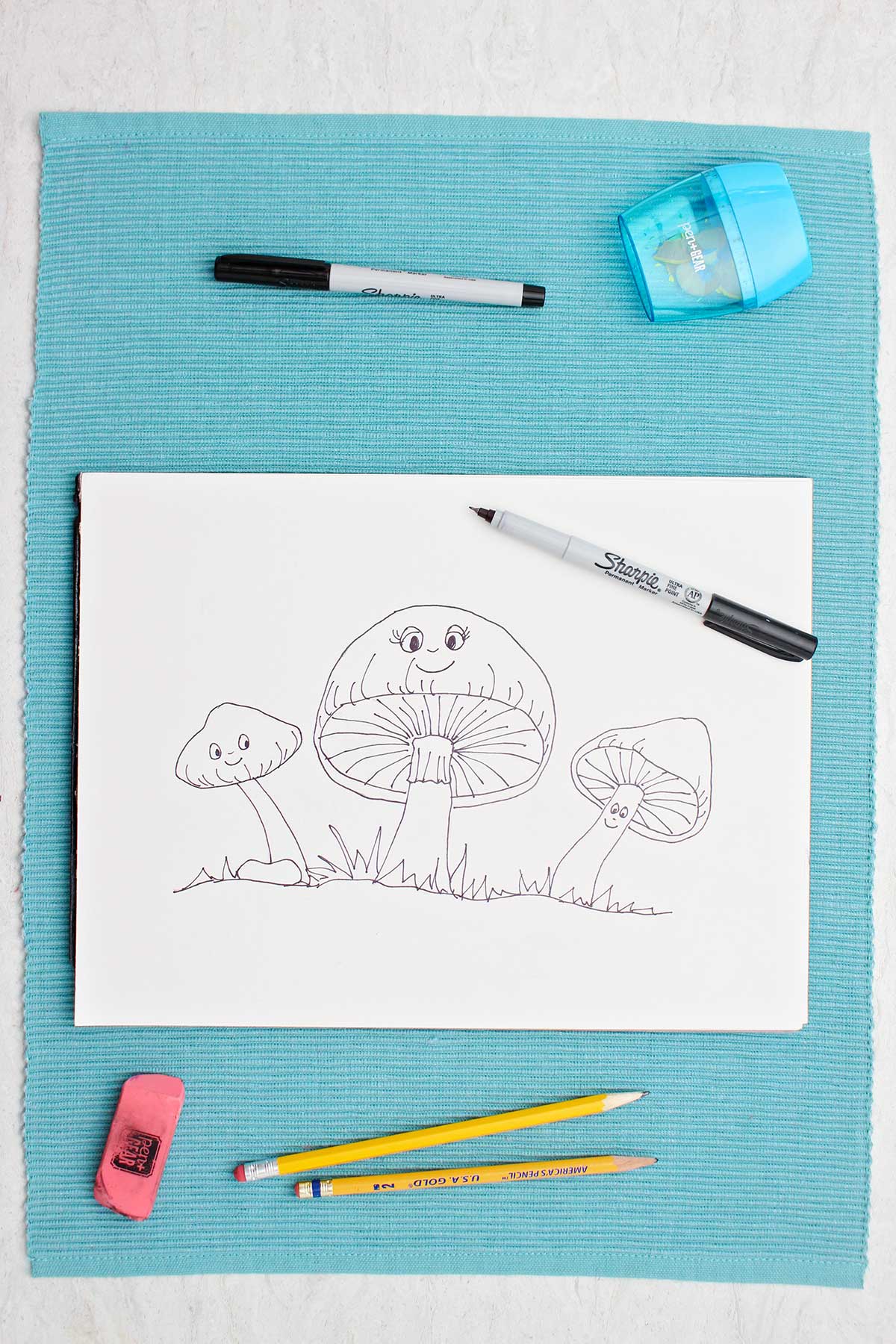 A pen drawing of cute mushrooms with faces