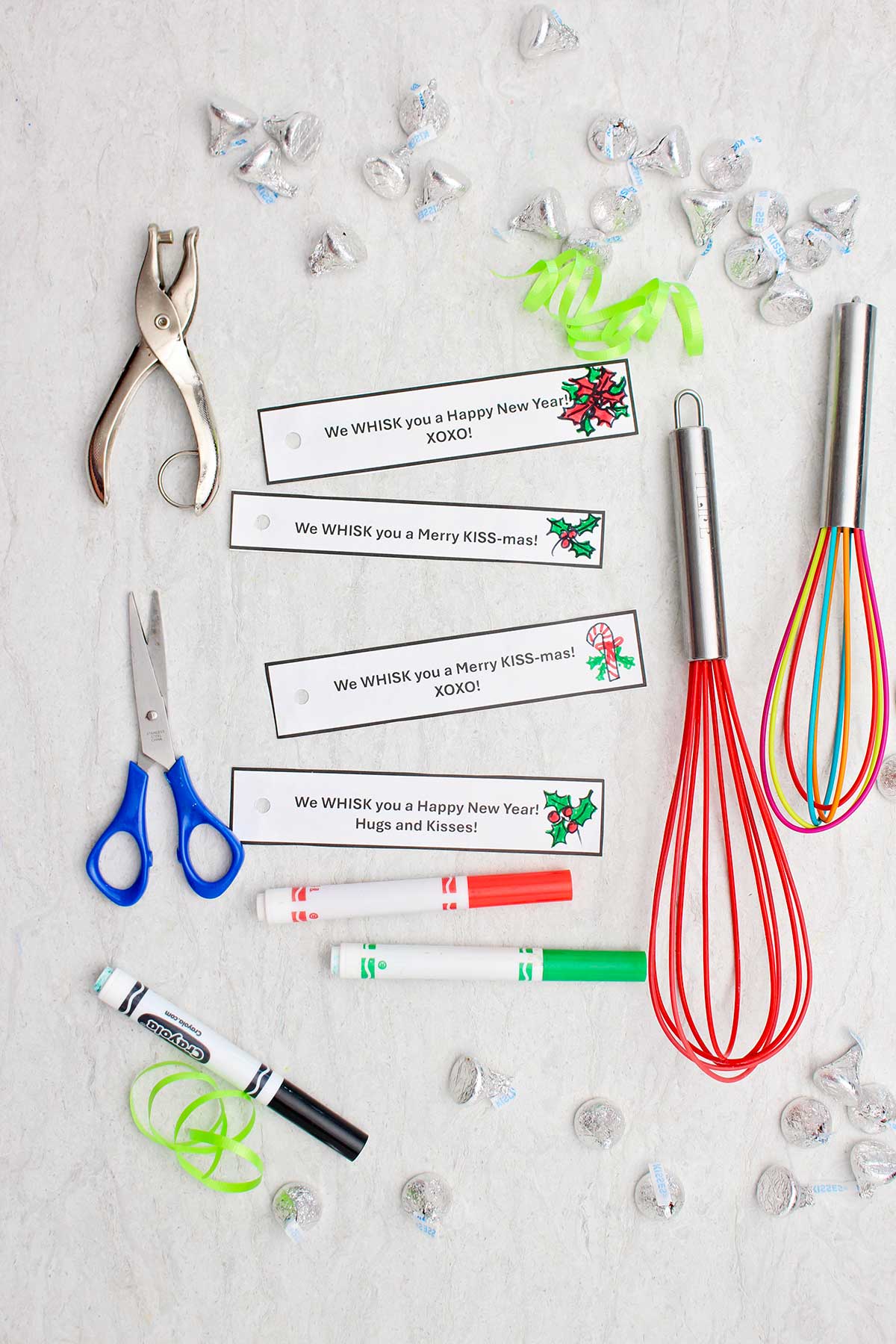 Cut out tags, whisks, scissors, candy, markers and ribbon.