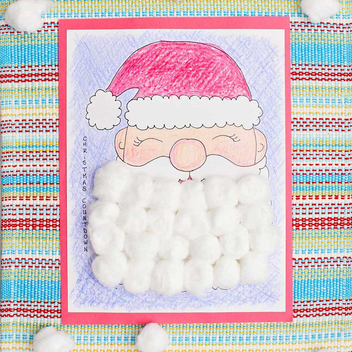A completed Christmas countdown calendar colored with crayon and Santa's beard covered with cotton balls.