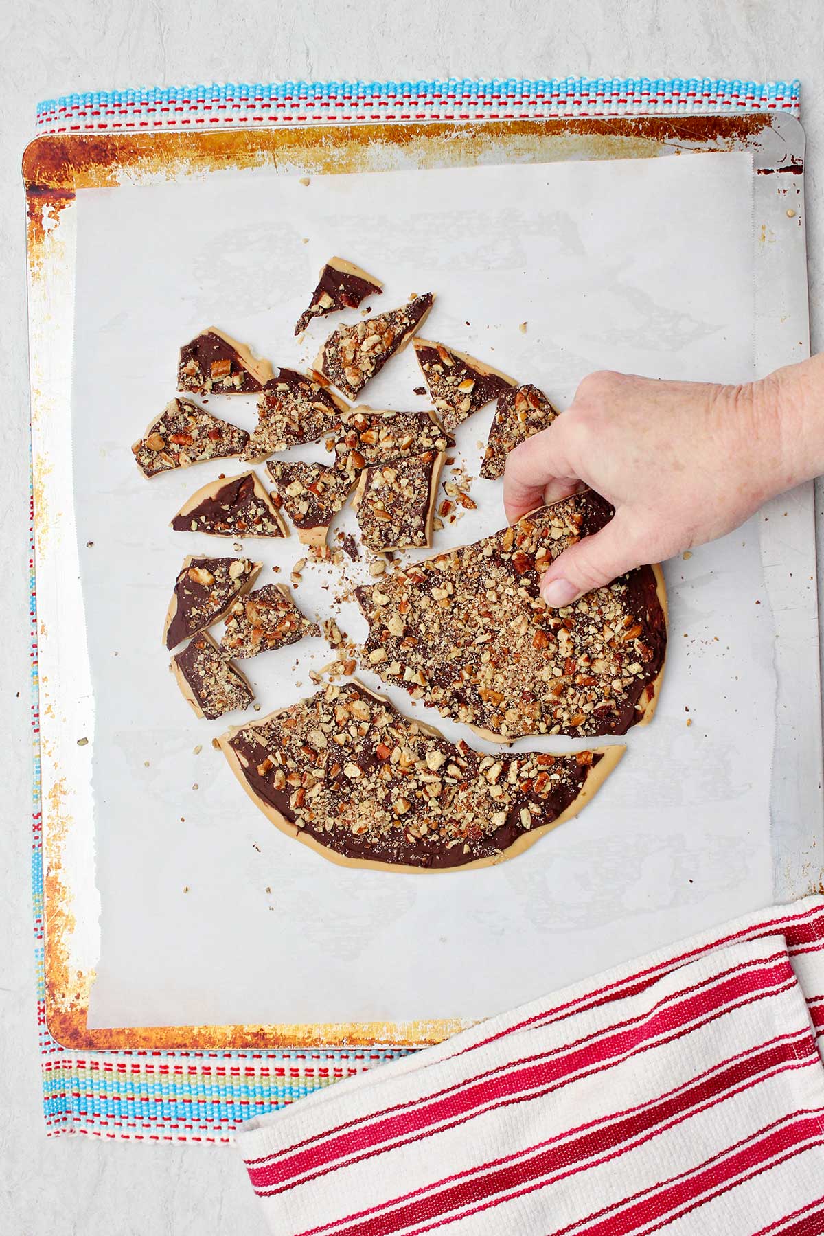 Person breaking cooled toffee apart.