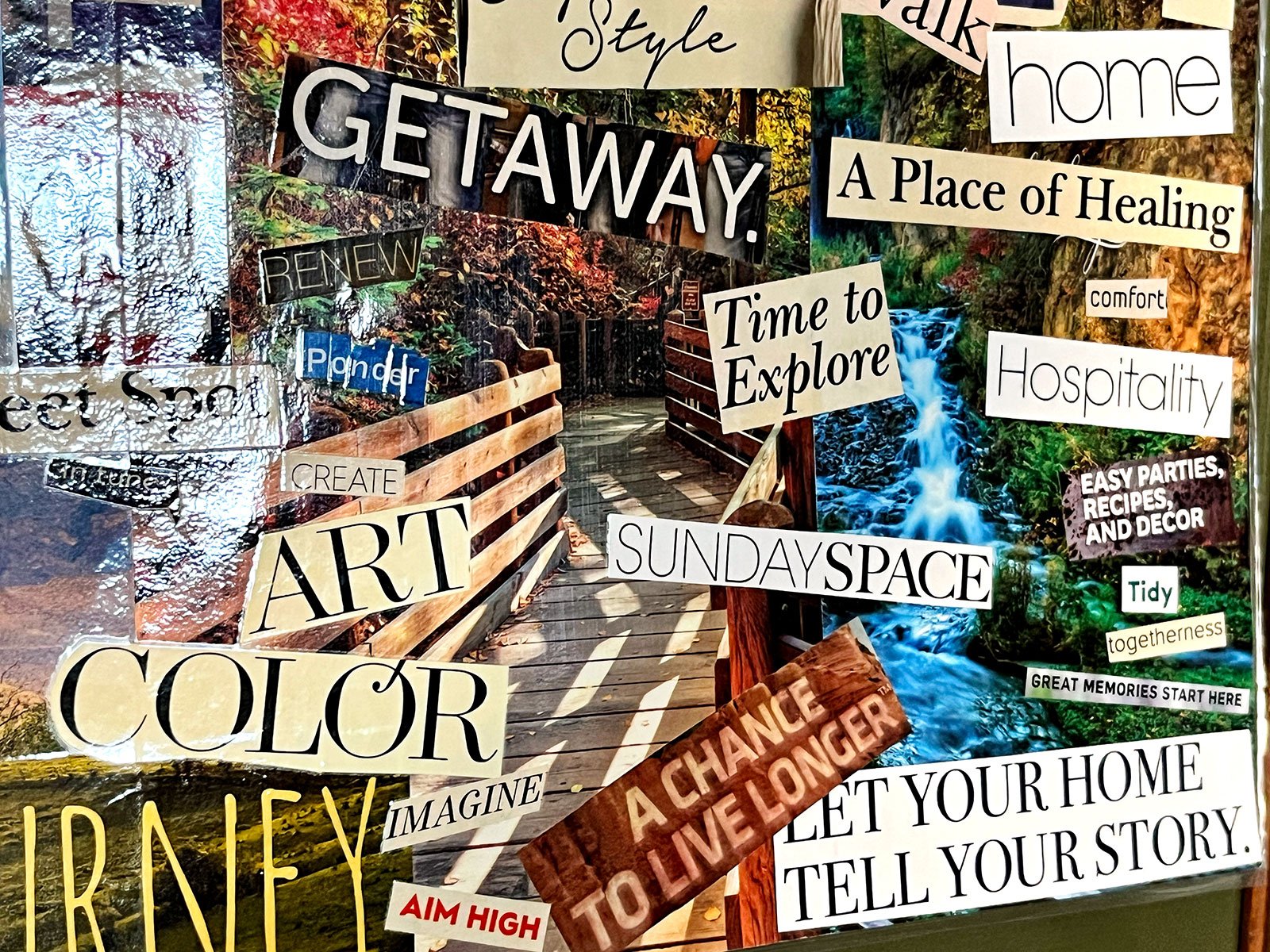 A close up of a magazine clipping vision board with bold text and bright colorful pictures.