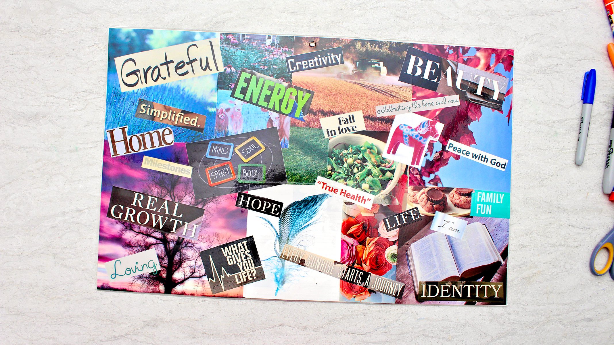 A vision board with bold text and jewel toned colorful photos.