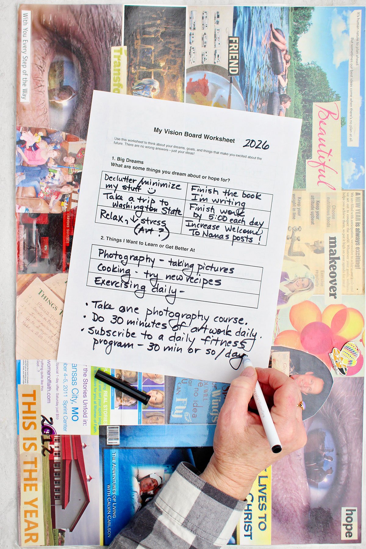 A person filling out dreams and interests on their vision board worksheet.