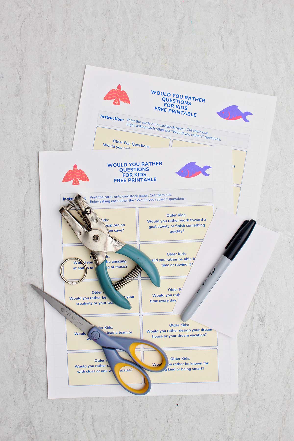 Printable Would You Rather questions for Kids with a hole punch, marker, and pair of scissors