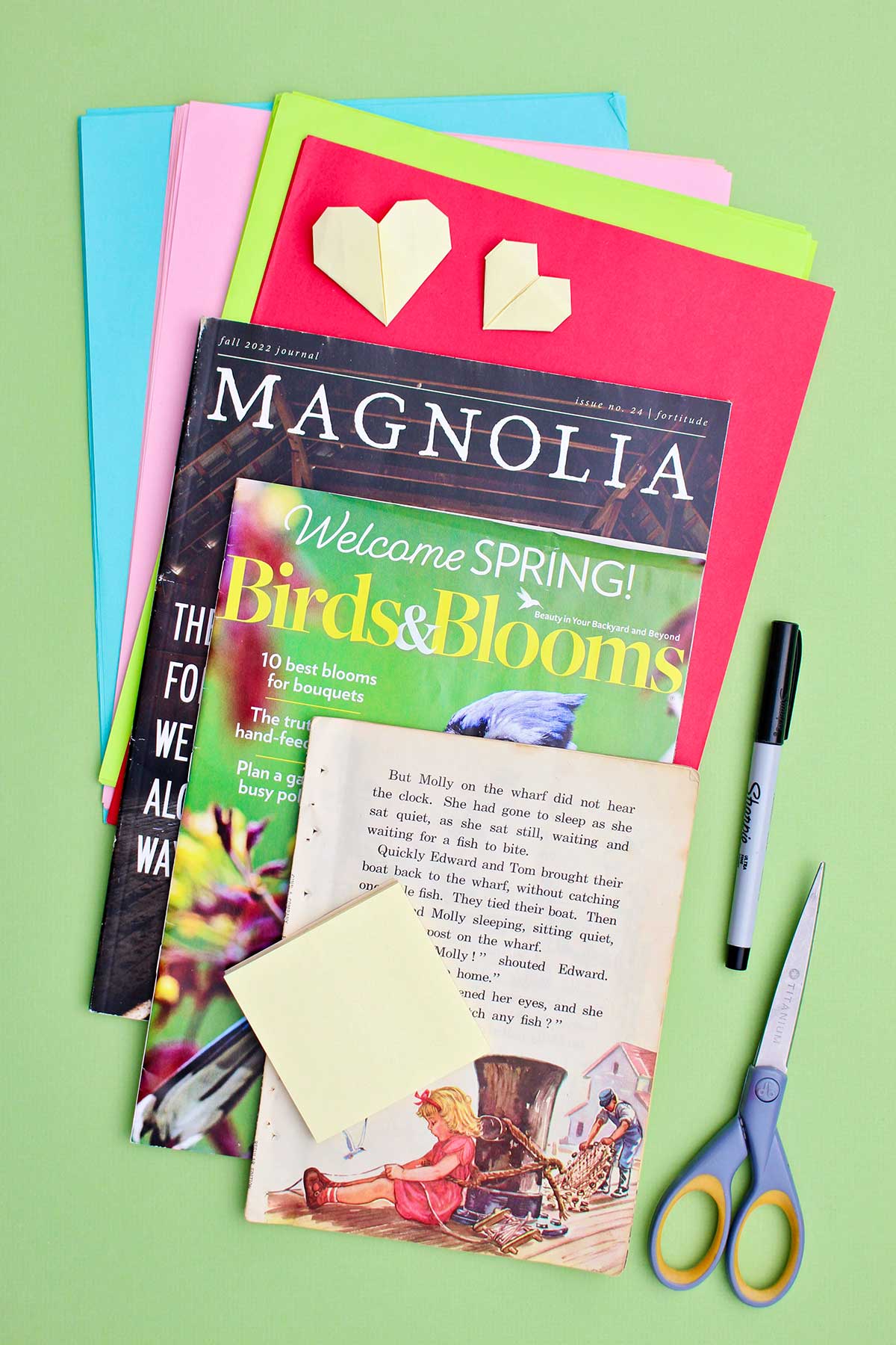 Magazine pages and colorful papers, scissors, sharpie and post it notes.