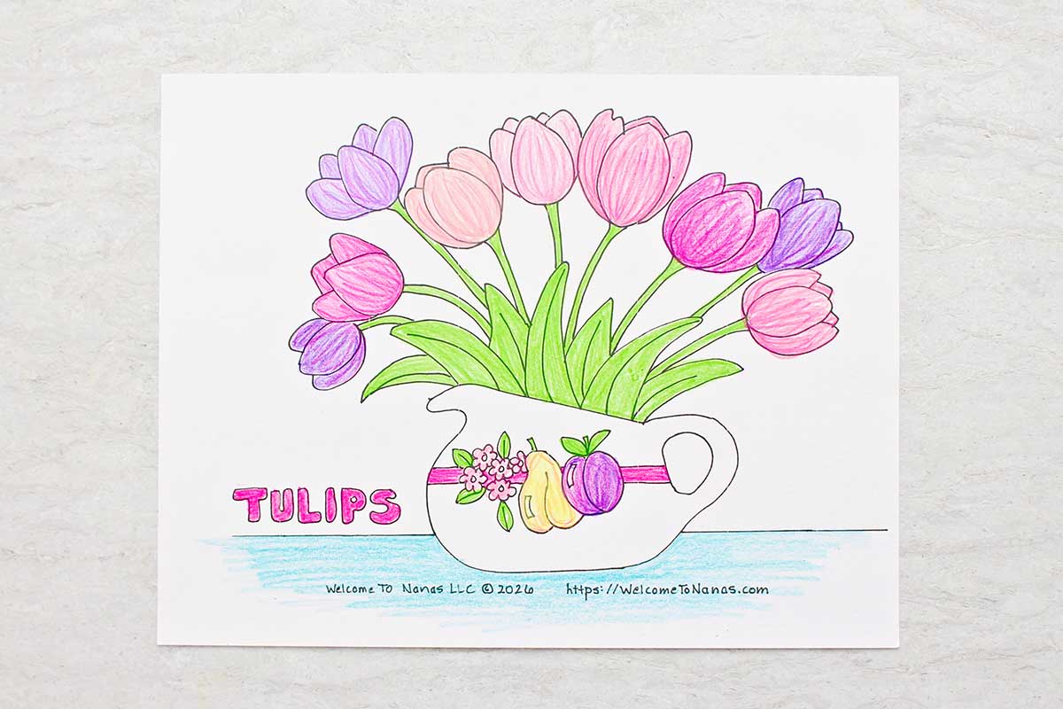 A completed coloring page of a handled vase full of pink and purple tulips.