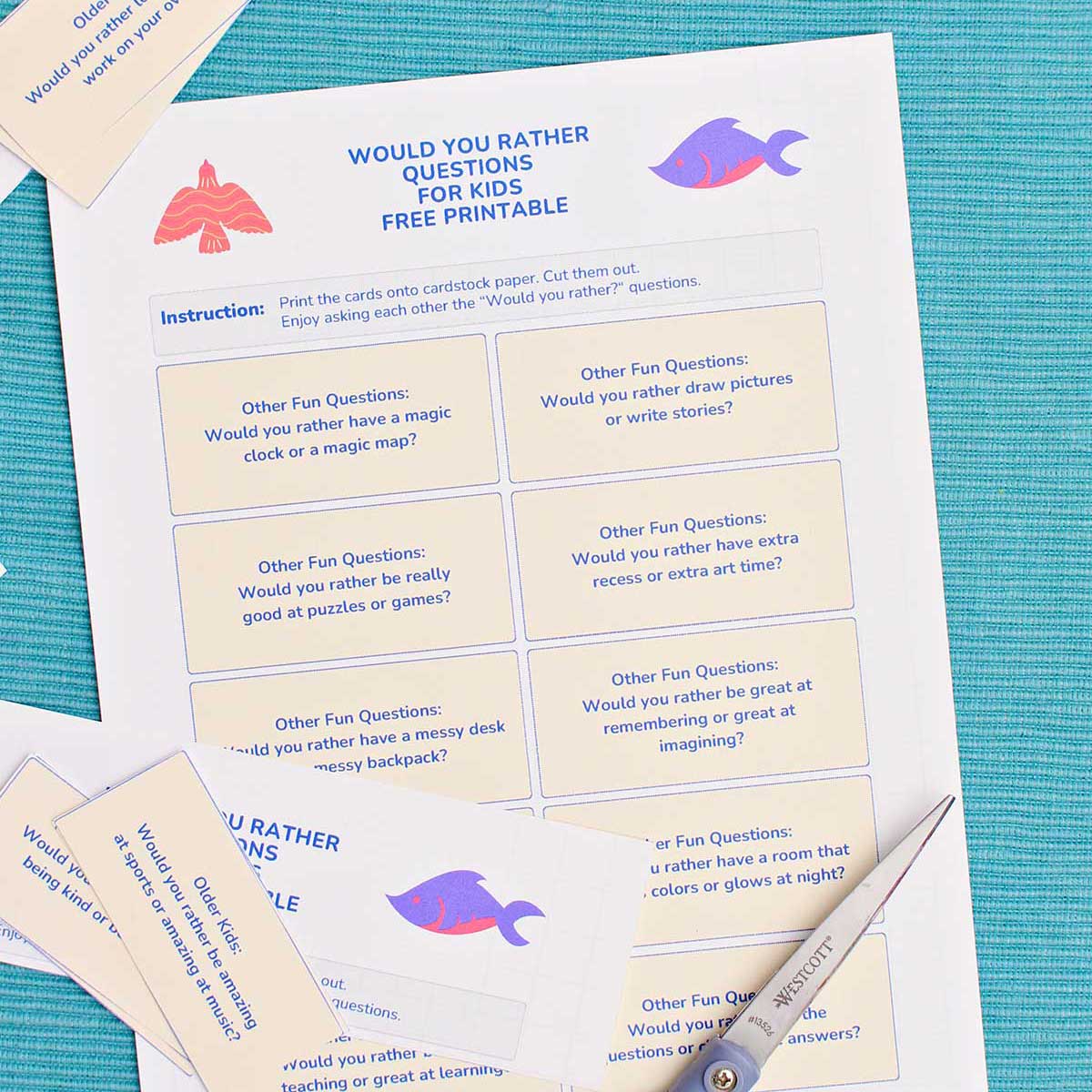 A printable with Would You Rather Questions near a pair of scissors