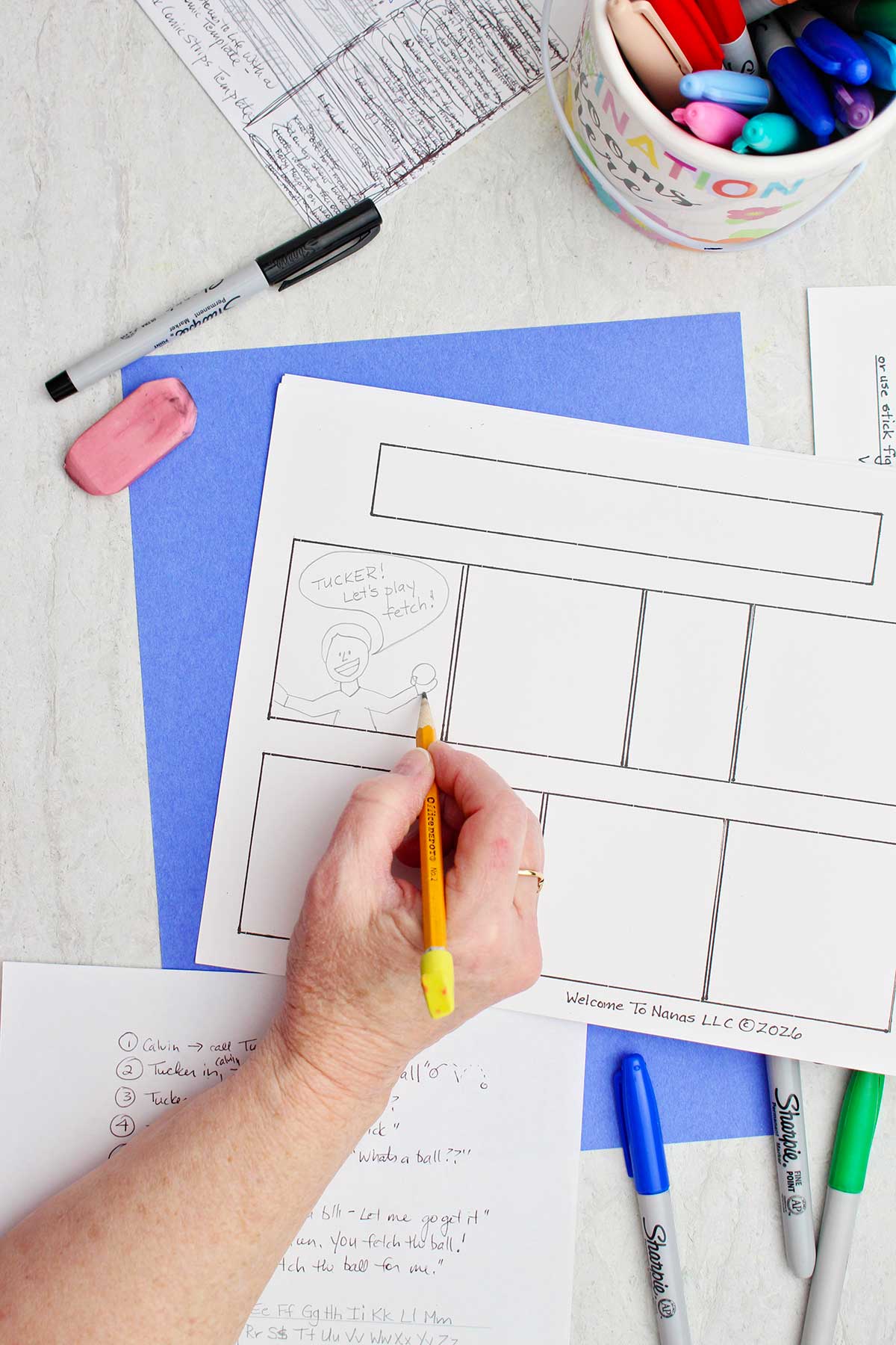 A person using a pencil to sketch out the beginnings of a comic book strip story.