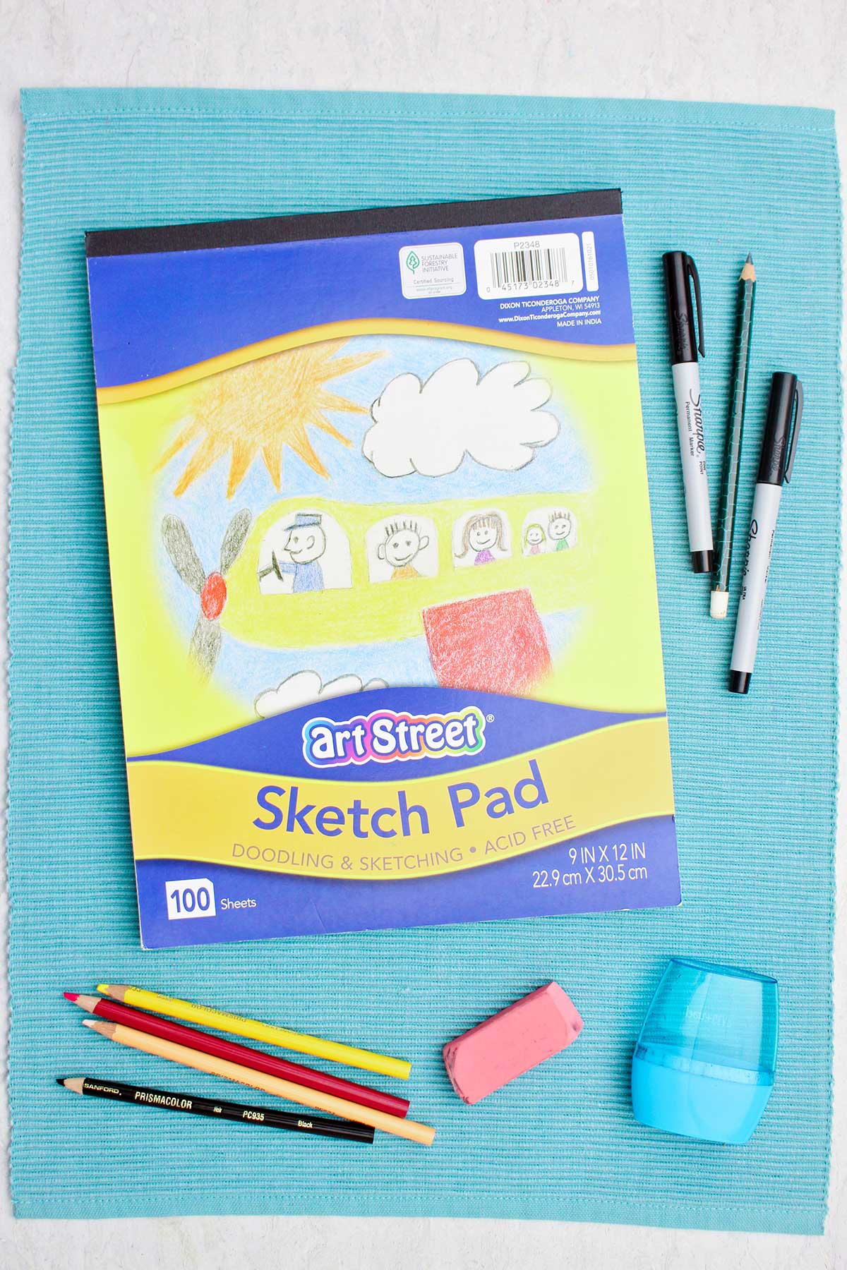 A sketch pad, Sharpie markers, colored pencils and eraser.