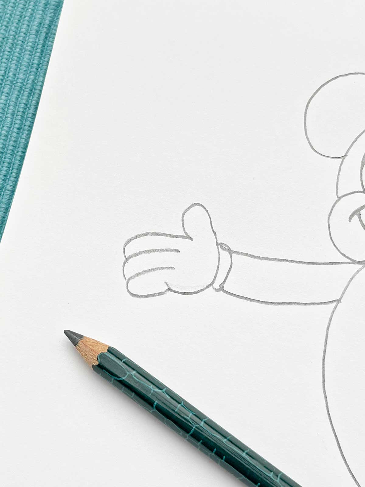 A close up of a pencil sketch of Mickey's hand.