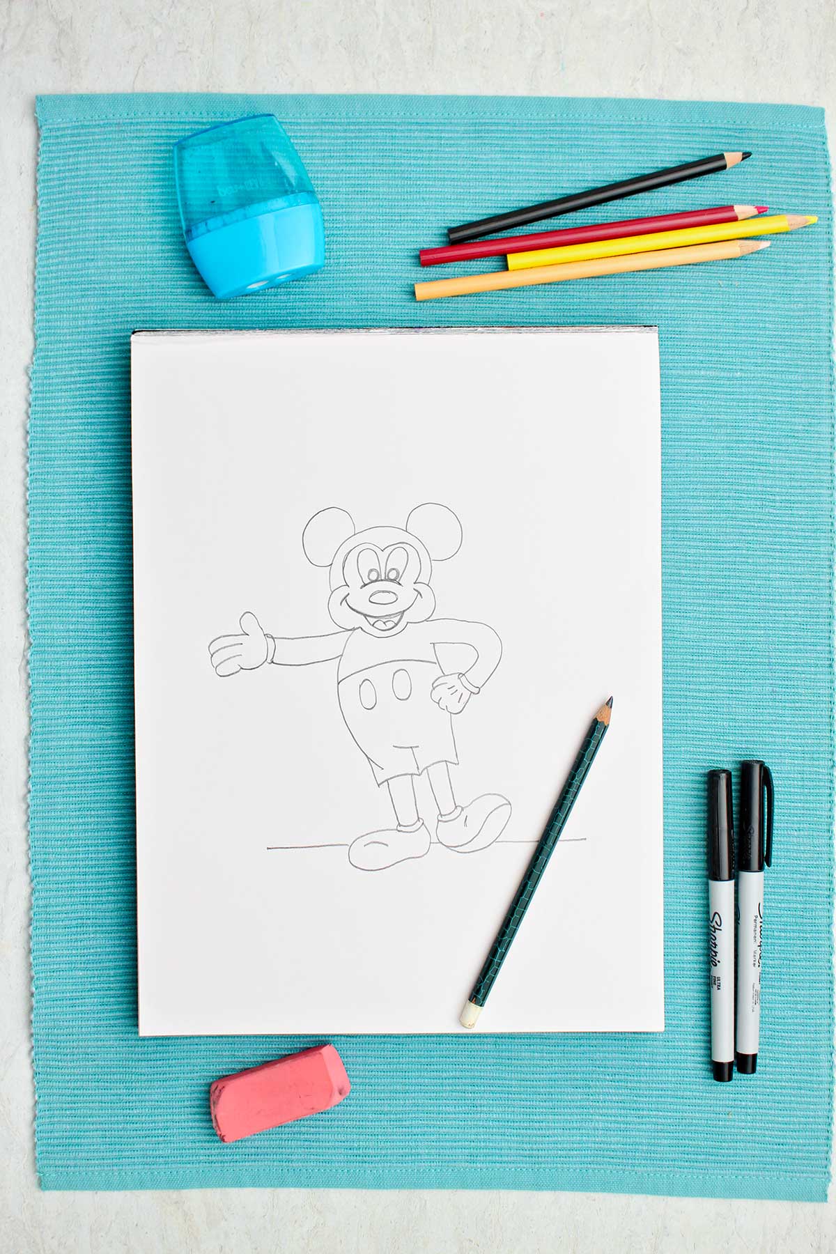 A completed pencil sketch of Mickey Mouse.