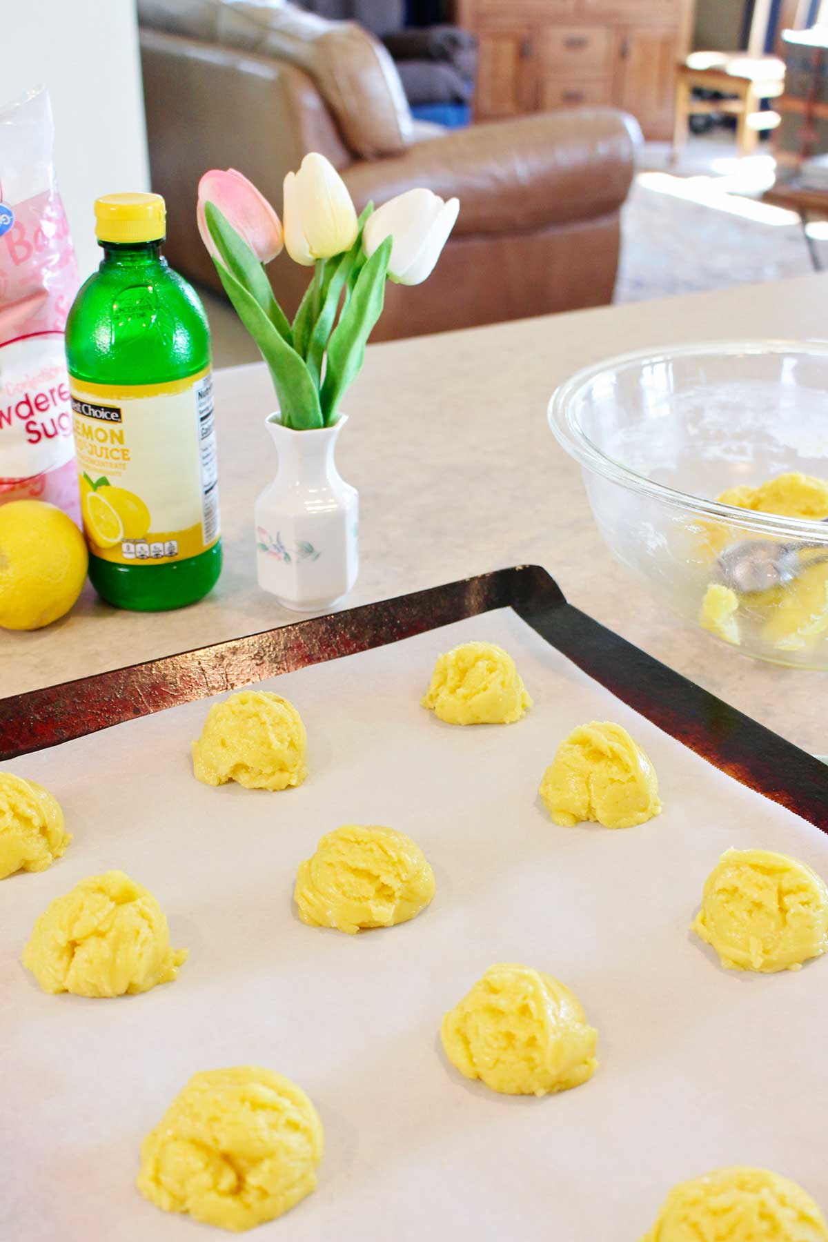 Lemon cookie dough on a piece of parchment paper ready to be baked.