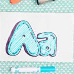 Bubble letter "A" in upper and lowercase shadowed in sharpie and colored in with blue marker lines.