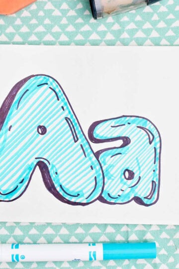 Bubble letter "A" in upper and lowercase shadowed in sharpie and colored in with blue marker lines.