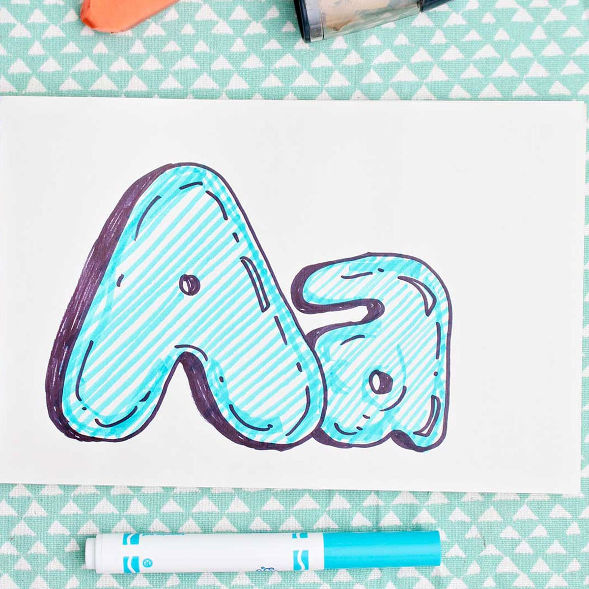 Bubble letter "A" in upper and lowercase shadowed in sharpie and colored in with blue marker lines.