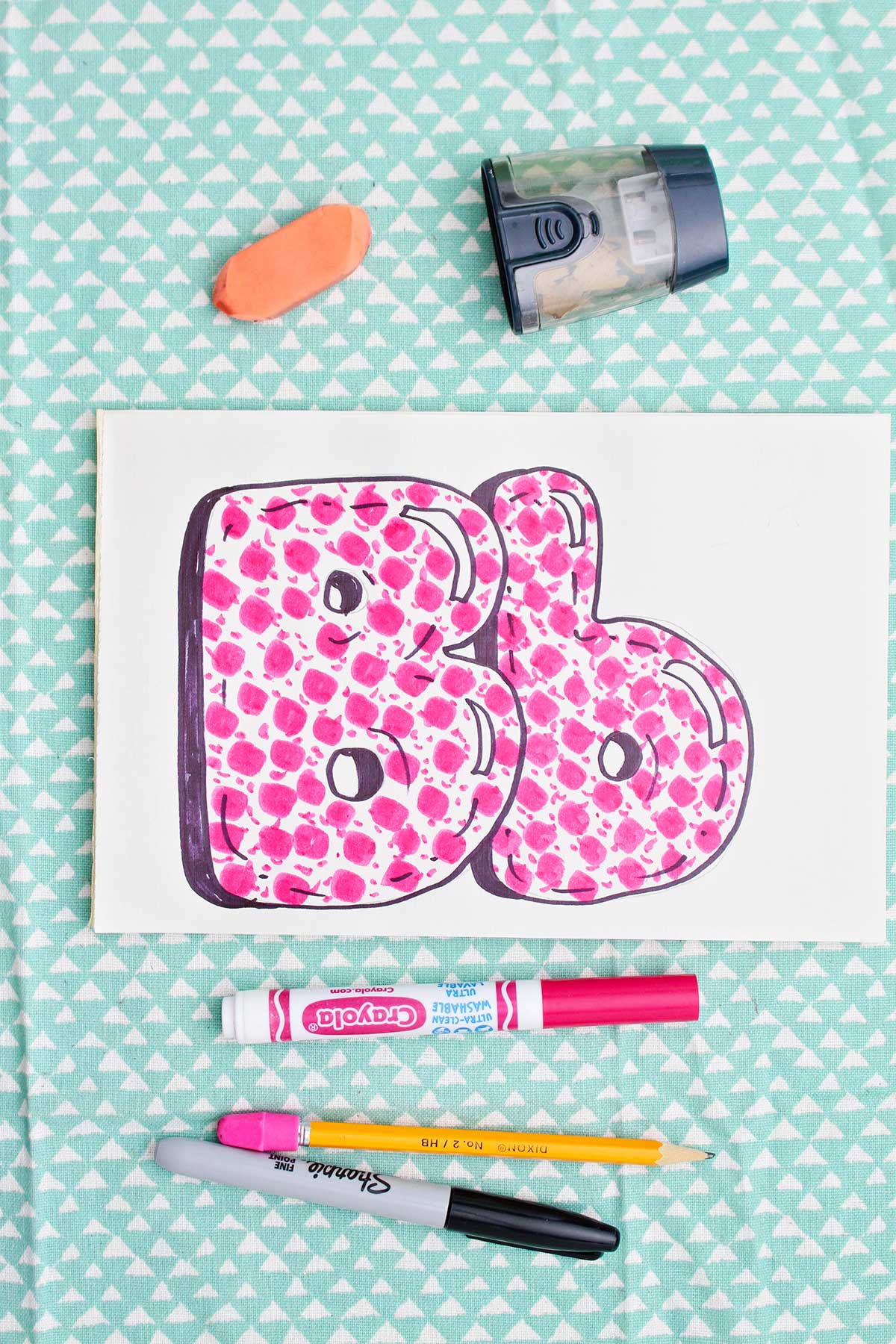 Bubble letter "B" in upper and lowercase shadowed in sharpie and colored in with pink marker pattern.